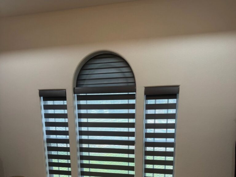Zebra blinds on an arched window and two side windows