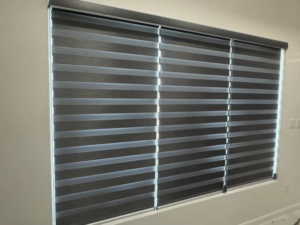Close-up of zebra blinds with alternating sheer and solid bands