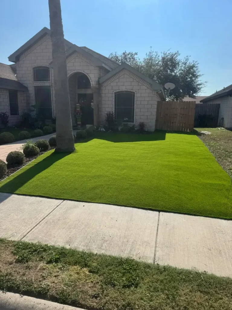 Front yard with green turf in front of a brick home