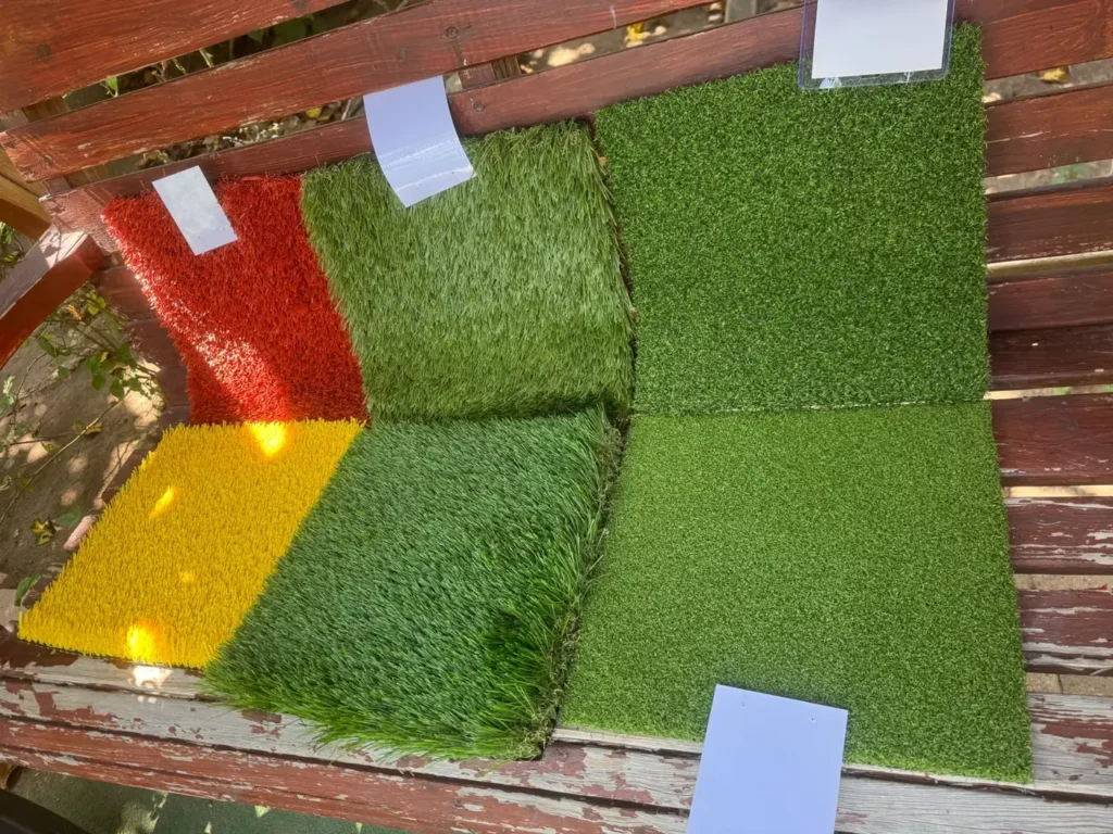 Turf samples in several colors and textures on a wooden bench